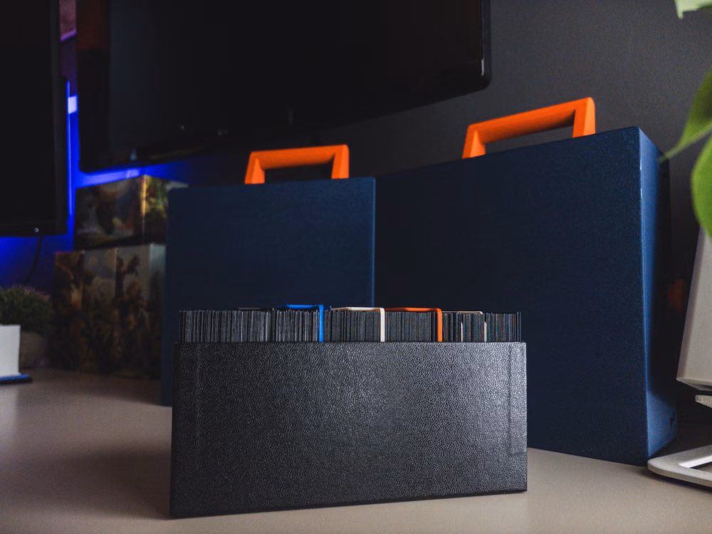 A single deck box holding one set of cards, colored stripes visible along the top edge of the sleeves.