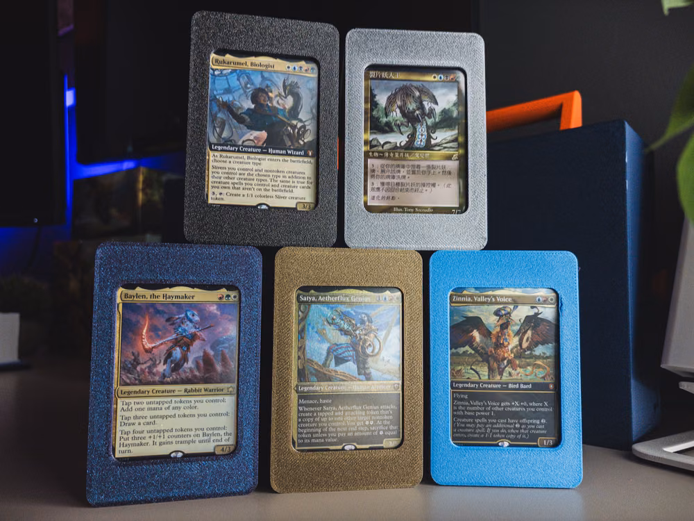 Five Commander decks displayed in separate colored deck frames, each with its own commander and its own copies of every staple.